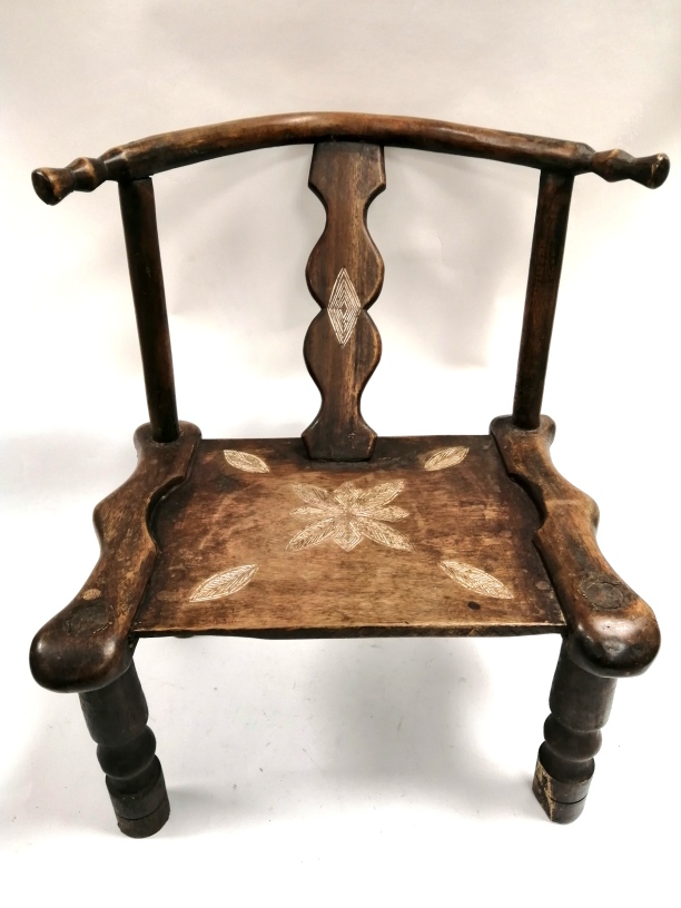 A Chinese horseshoe child's chair, with turned legs, the central splat with carved diamond and an