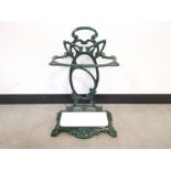 Art Nouveau form cast iron stick stand, deep green glaze finish and white dropin inserts. 42cm W x