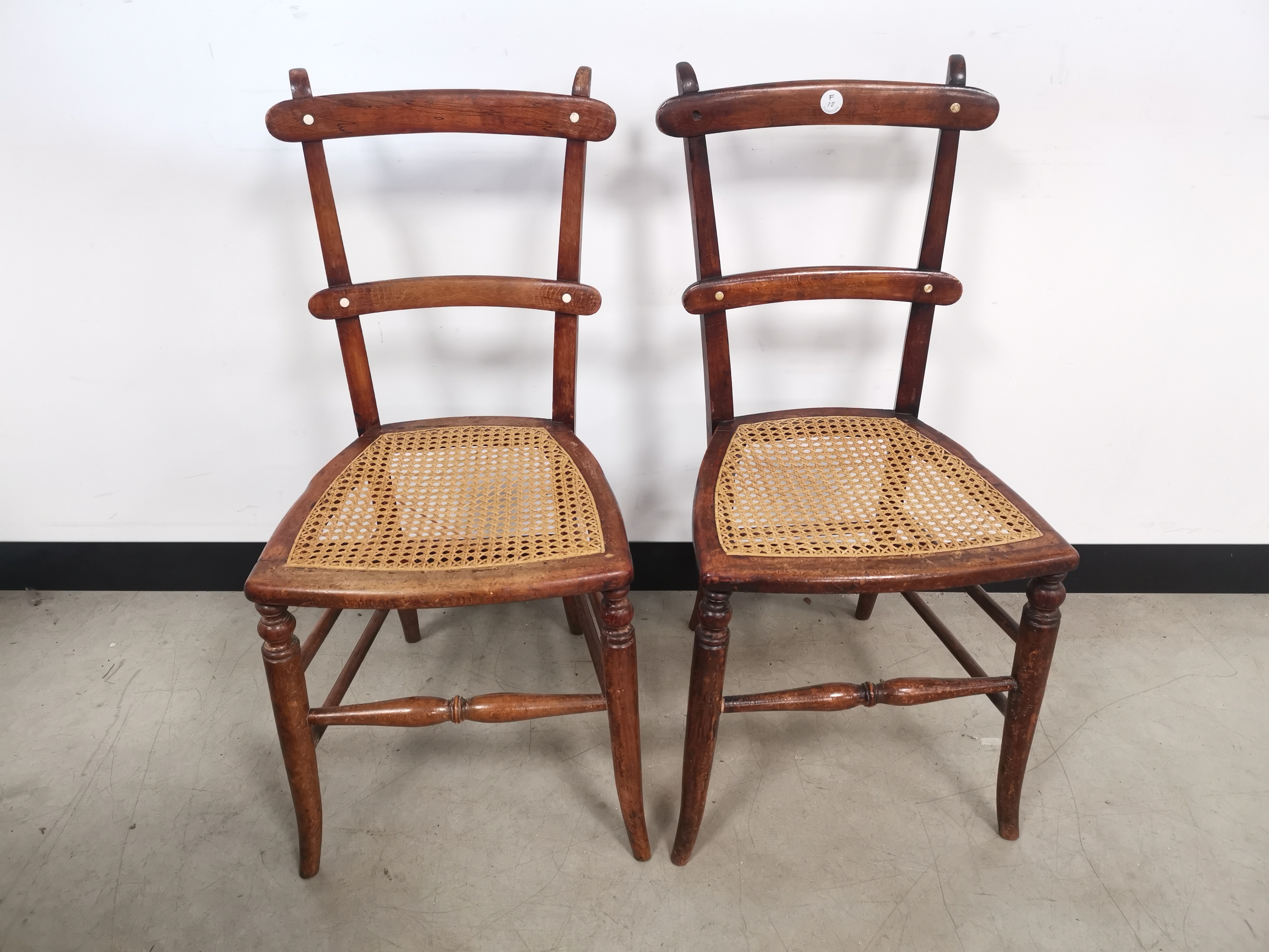 A pair of side chairs, with cane seats.