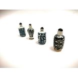 A group of four Chinese blue and white snuff bottles, two with encircling dragon designs with
