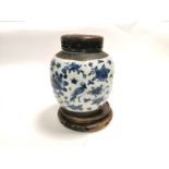 An Asian crackleware vase with underglaze blue rendering of flower heads and birds, with unglazed