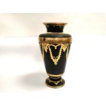 An Asian lacquered wood vase with gilt decoration of butterflies conjoined to garlands of plant