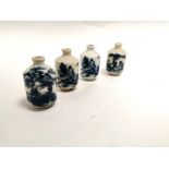 A group of four Chinese blue and white snuff bottles of identical form, two with the same female
