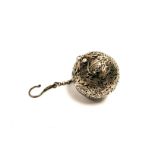 A Middle Eastern Islamic white metal incense ball, of pierced form, with decoration of birds and