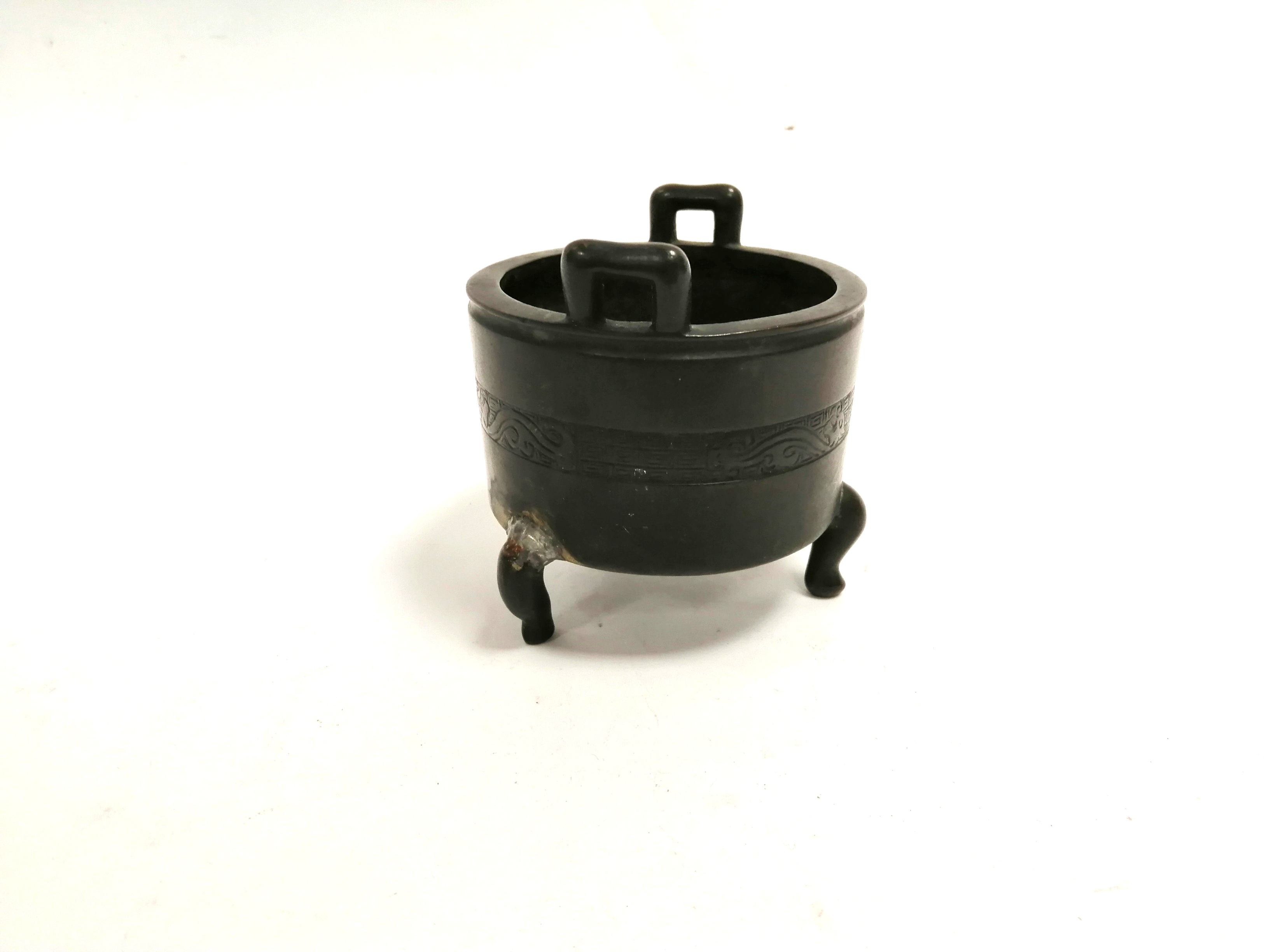 A Chinese tripod censer of twin handled barrel form, height 9cm