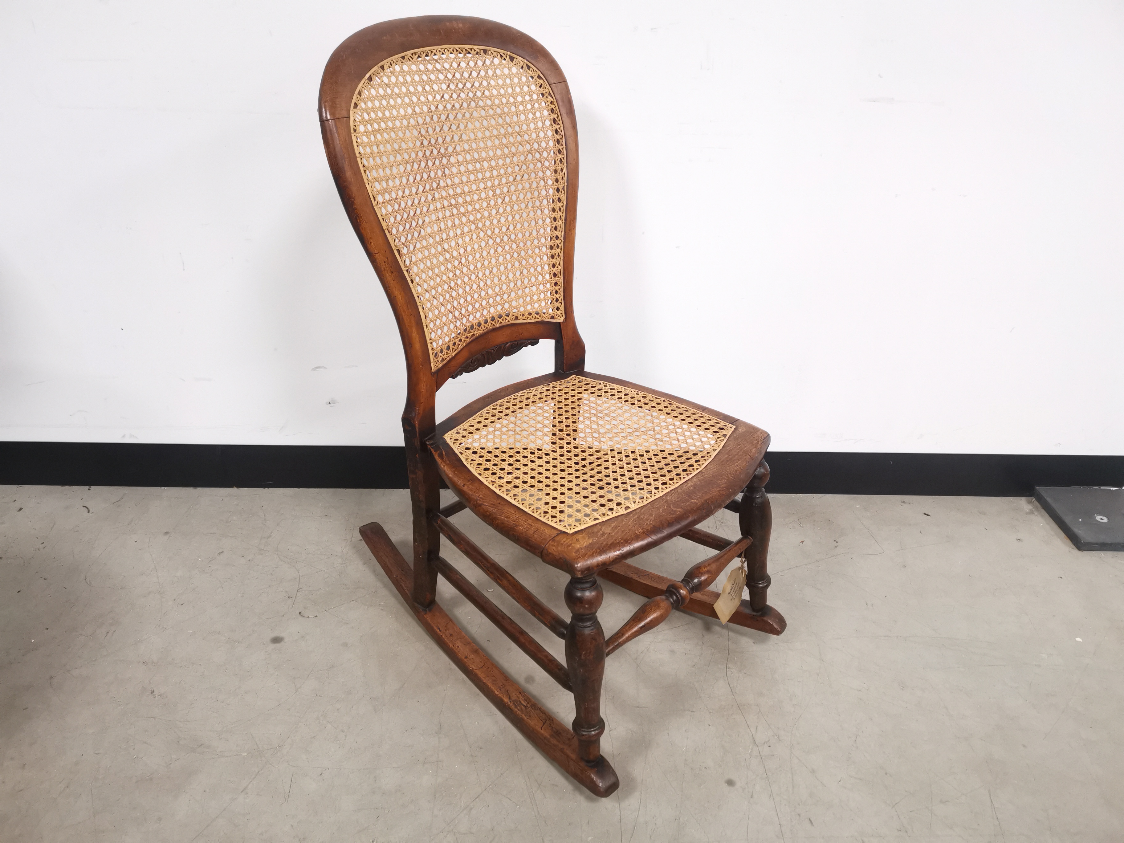 19th Century bergere rocking chair, with turned spindle supports. 41cm W x 64cm L x 88cm H