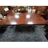 Extending mahogany dining table, With additional leaf, raised on two pedestals.