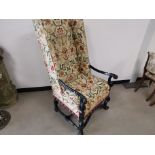 Lacquered high back arm chair, With scroll form frame, floral upholstery on cream ground.