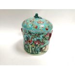 A Chinese covered pot with overglaze polychrome decoration of chickens, on a turquoise ground,