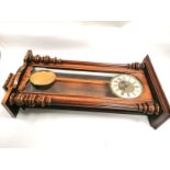 A mahogany cased Vienna style wall clock, with brass and enamel dial and roman numerals, length