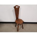 Oak spinning stool, With carved detail to the seat and back rest.
