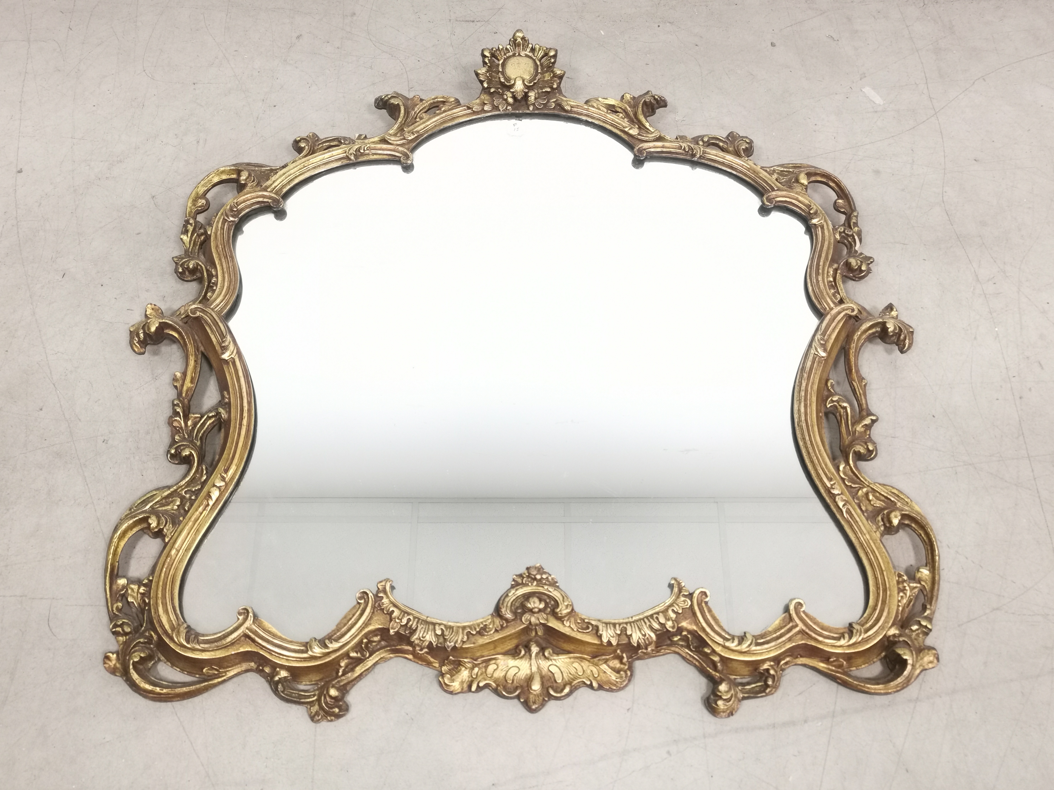 Scroll form gilt framed mirror