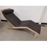 Modern Scandinavian style formed plywood lounger, with leatherette cushioning in dark brown. 162cm L
