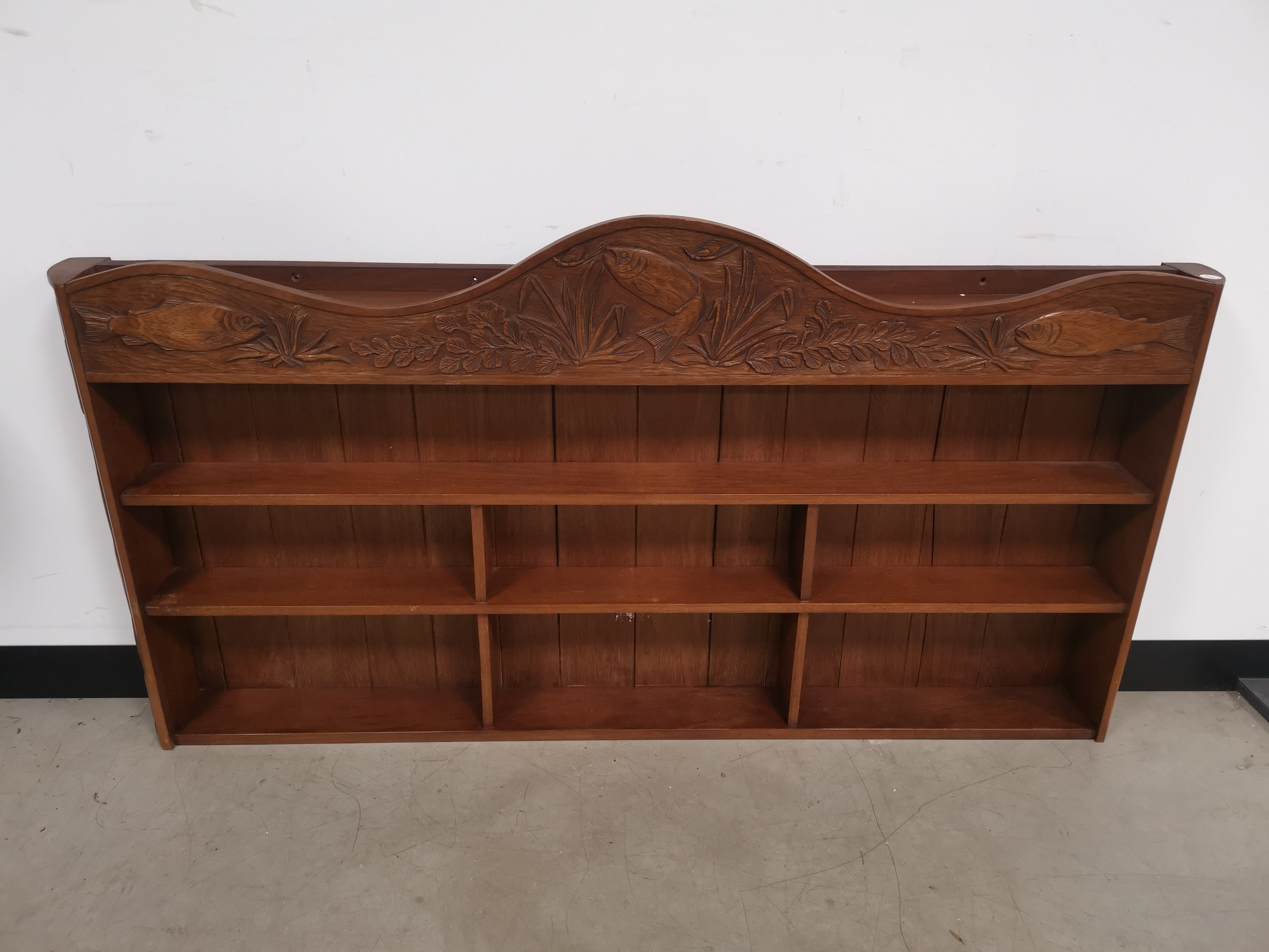 Oak hanging angling themed shelving unit, with carved decoration of fish and reeds.