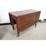 19th Century mahogany drop leaf table, raised on reeded supports and castors. Having later top.