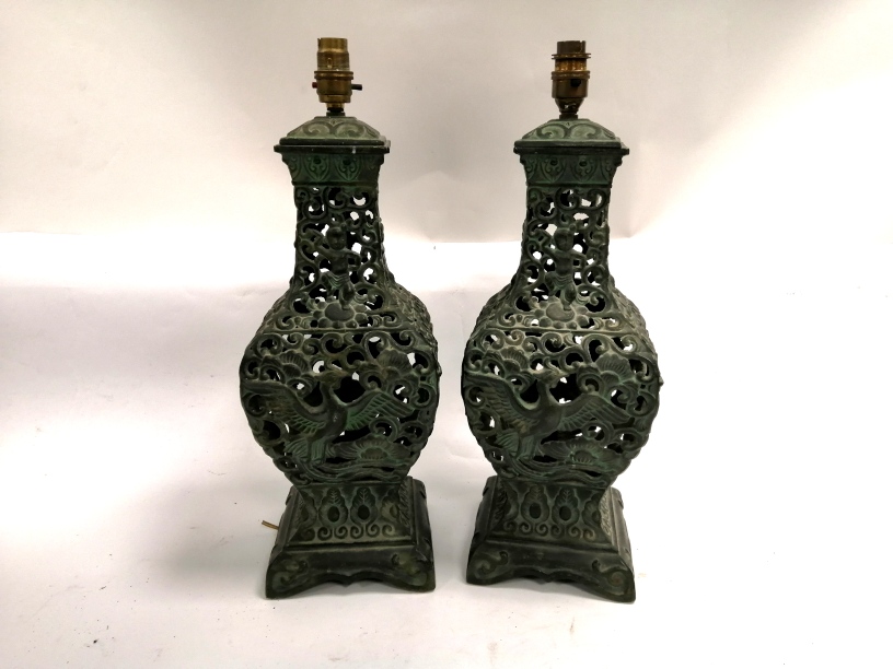 A pair of Chinese cast metal lamp bases with a design of phoenixes and dancing boys, height 50cm