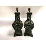 A pair of Chinese cast metal lamp bases with a design of phoenixes and dancing boys, height 50cm