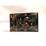 An early 20th Century black lacquer bound photograph album, with a waterside and mountain scene,