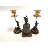 A garniture of 19th Century cold painted bronze performing bear candlesticks, raised on marble