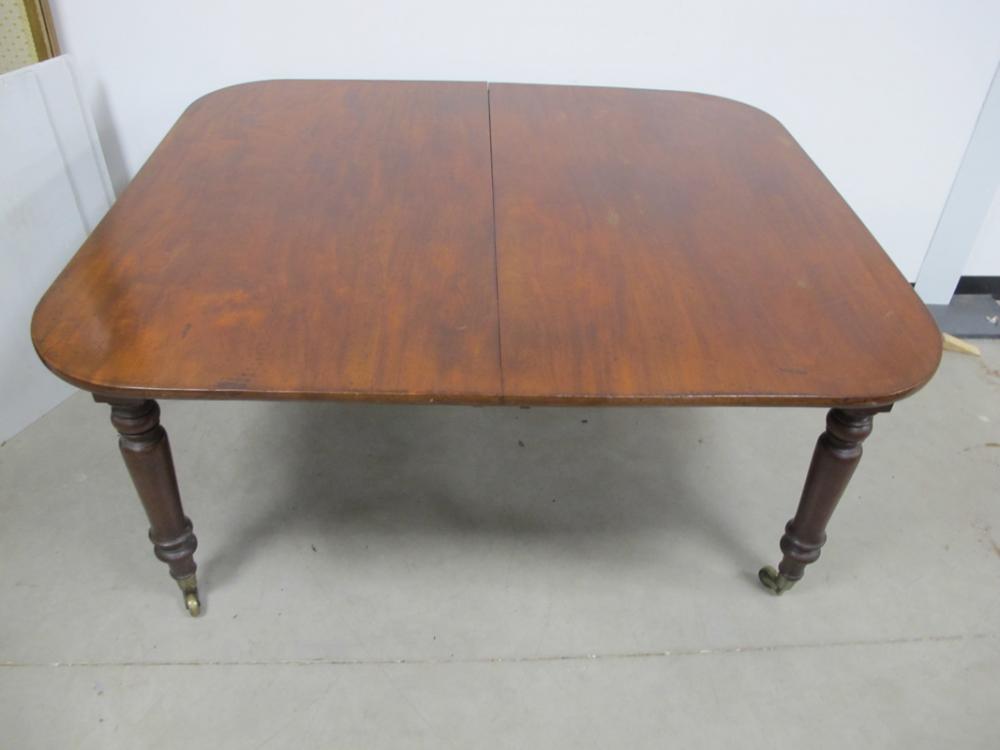 A 19th Century mahogany dining table, drawer leaf action, rounded top with two extra leaves,