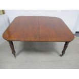 A 19th Century mahogany dining table, drawer leaf action, rounded top with two extra leaves,
