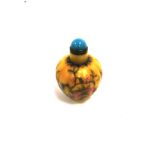 A yellow ground Chinese snuff bottle of organic form, decorated with fruiting and flowering vines,