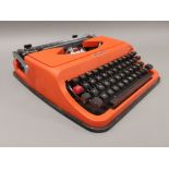 A cased Underwood 35 portable typewriter, finshed in bright orange.