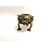 An Asian brass tripod mythical creature censer, with expressive face and void in mouth, probably