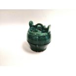 A green glazed Asian water pot, of barrel form, with rough unglazed base, height 21cm