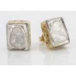 A pair of silver gilt and diamond slither stud earrings, in rubbed over settings of rectangular