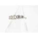 A diamond five stone platinum set dress ring, brilliant cuts in rubbed over settings on white