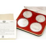 A set of four Canadian Mint uncirculated silver Olympic coins, two 1974 $10 and two 1976 $5 coins in