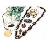 A quantity of costume jewellery, including a baby brooch, white metal brooch, various beads etc