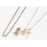 A collection of 9ct gold necklaces, with two religious charms of the Madonna and a cross together