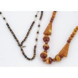 A three strand tiger's eye and freshwater blister pearl necklace, the spherical tiger's eye