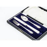 A 1920s silver three piece Christening set, in fitted box, spoon and fork with initials EH