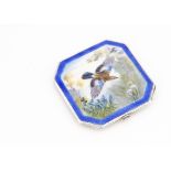 An Art Deco period silver and enamelled compact by NCD, having swooping jay amongst flowers to