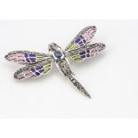 A white metal plique a jour dragonfly brooch, set with cabochon ruby eyes, sapphire abdomen and