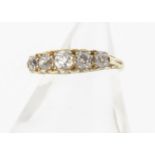 An 18ct gold five stone diamond ring, the old cut diamonds in claw settings with scroll gallery,