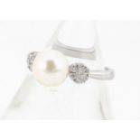 A cultured pearl and diamond 9ct gold dress ring, the central pearl flanked by two clusters of