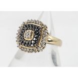 A 9ct gold black and colourless diamond cluster ring, of square tablet form, ring size P, 5g