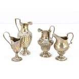 A group of four 19th and 20th Century silver jugs, 11.5 ozt, some denting and damages (4)
