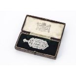 An Art Deco architectural platinum diamond and emerald brooch or pendant, of rectangular shape