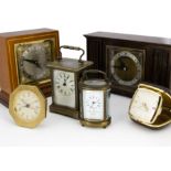 Six vintage and modern timepieces, including a damaged carriage timepiece, a smaller oval carriage