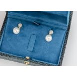 A pair of 9ct white gold diamond and pearl drop studs, the white pearls set in suspended loops on