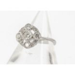 An Edwardian style diamond target ring, all in white metal stamped PLAT, brilliant cuts in colette