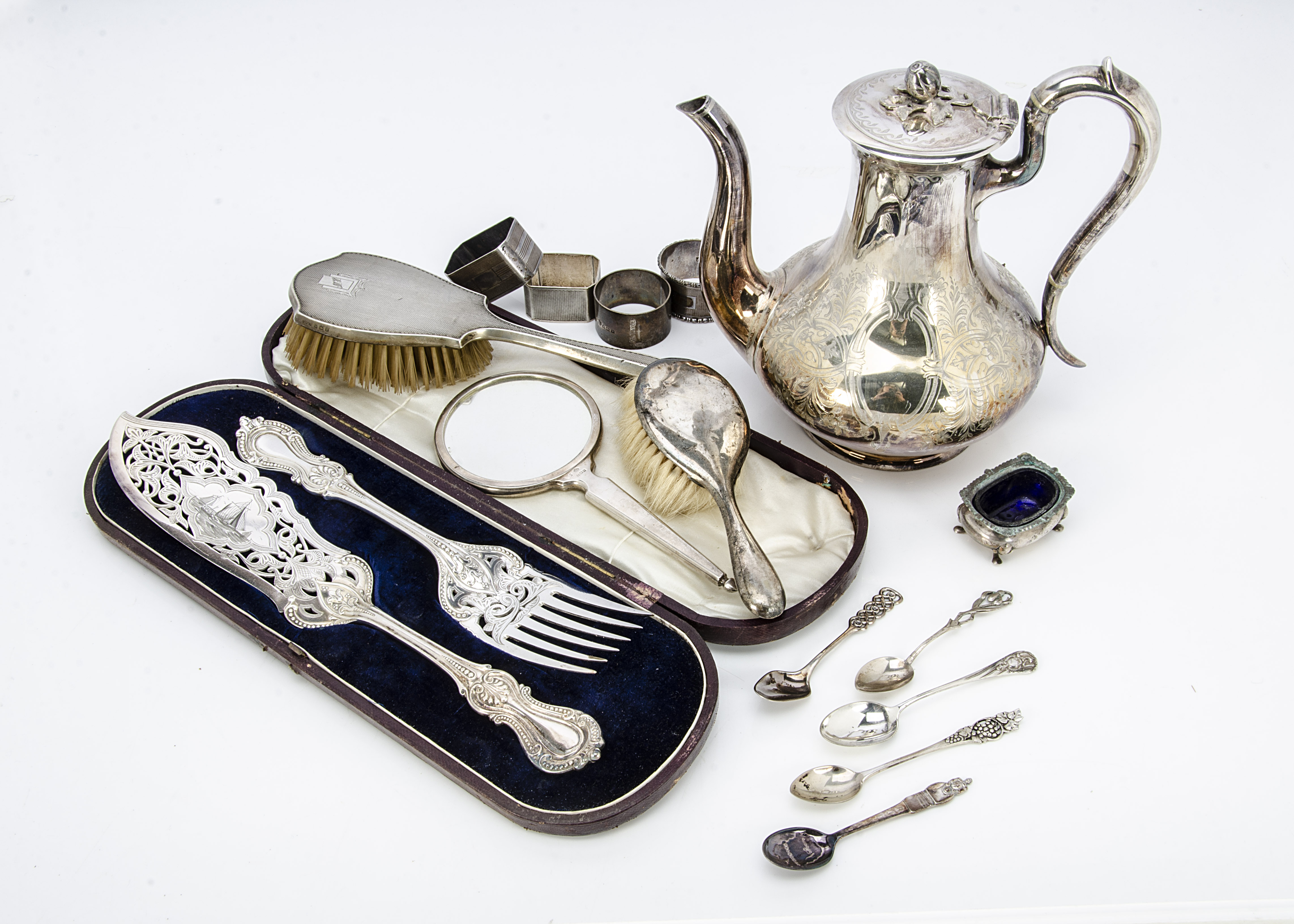 A collection of silver and silver plate, including four napkin rings, tea and coffee spoons, a