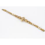 A continental citrine and yellow metal ornate bracelet, the five mixed oval cut gems in claw