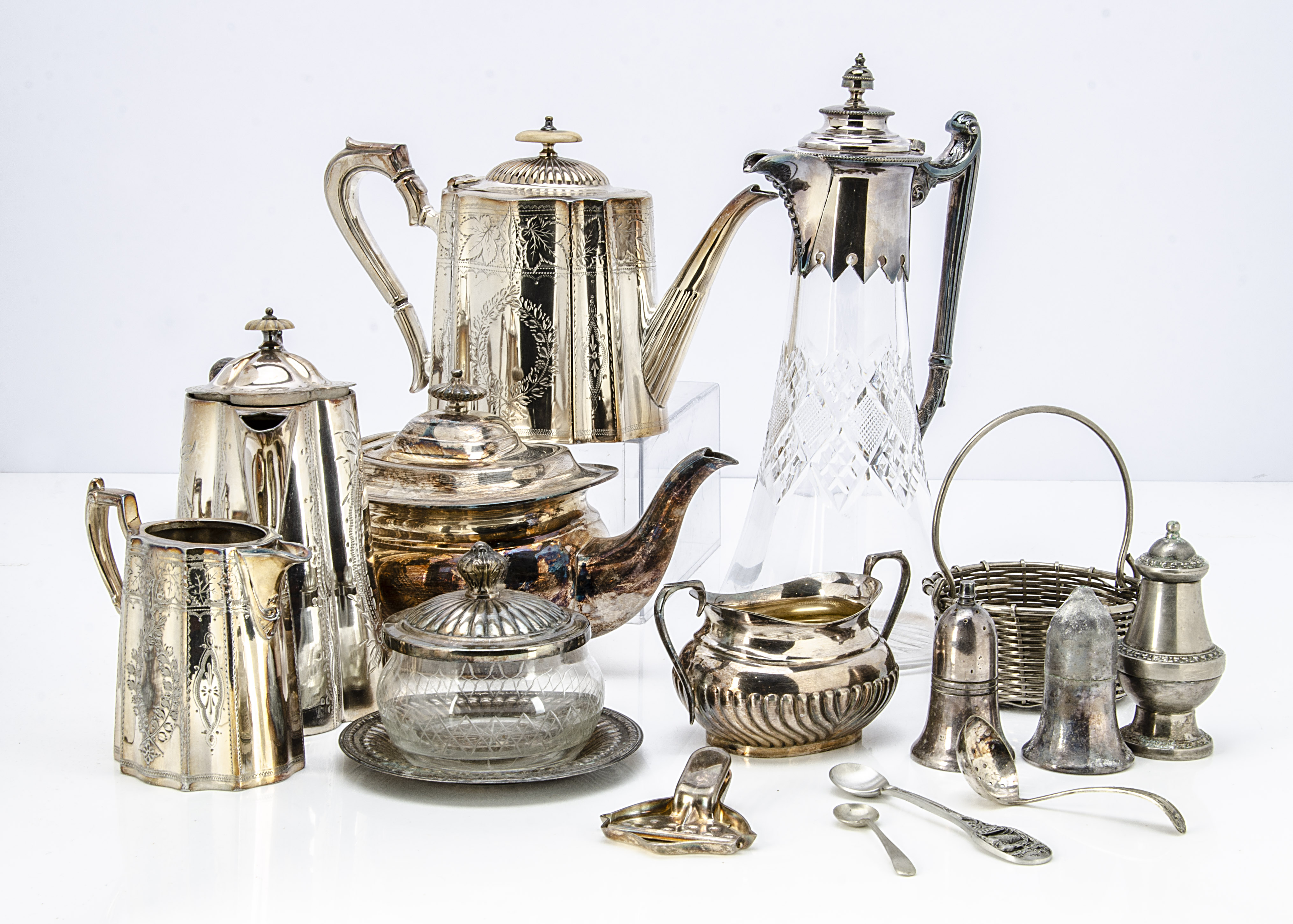 A collection of silver plate, including a cut glass claret jug, four piece tea set, a teapot, butter