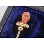 A 19th Century coral and yellow metal figural stick pin, bust of a classical female, af, 7.7cm, 1.